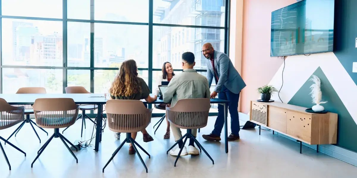Four people around a table in a modern offices